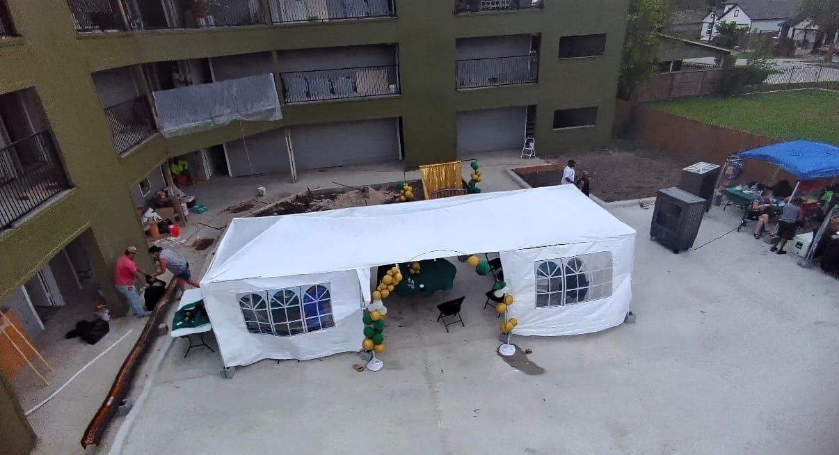 Aerial view of the courtyard with an event tent and guests gathered