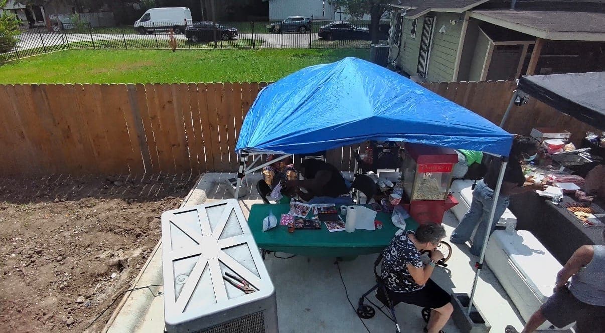 Aerial view of a canopy tent with tables and guests underneath