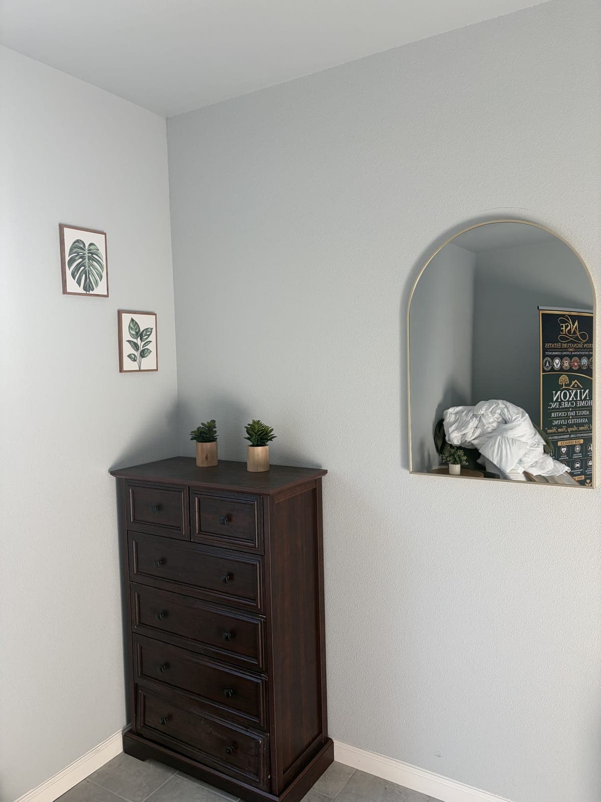 A corner of the bedroom in the furnished demo suite with a dresser